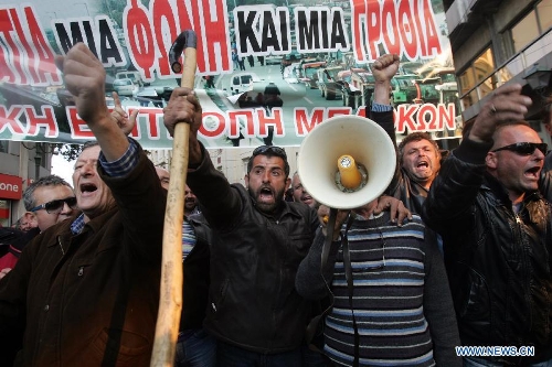 Greek farmers shout slogans and hold banners in central Athens of Greece, on March 5, 2013. Thousands of farmers from across Greece gathered in central Athens on Tuesday to rally in front of the parliament in protest of harsh austerity policies which have altered dramatically their everyday life over the past three years. (Xinhua/Marios Lolos) 