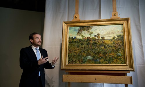 Alex Rueger, director of the Van Gogh Museum in Amsterdam, presents a painting by Vincent van Gogh, entitled <em>Sunset at Montmajour</em> and painted in 1888, on Monday in Amsterdam. Photo: CFP