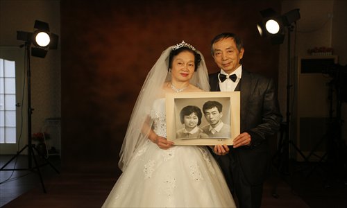 Romantic Mr Wang, 66, and his wife, 63, pose for a new wedding photo 32 years after their original wedding photos were taken at the Renmin Photo Studio. Photo: Cai Xianmin/GT
