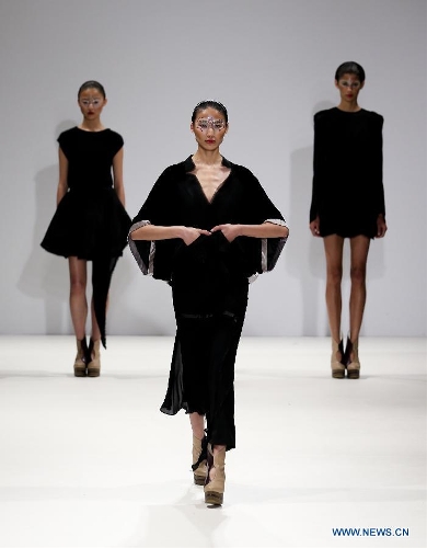 Models present creations of Chinese designer Jenny Ji during London Fashion Week in London, Britain, on Feb. 18, 2013. (Xinhua/Tang Shi)