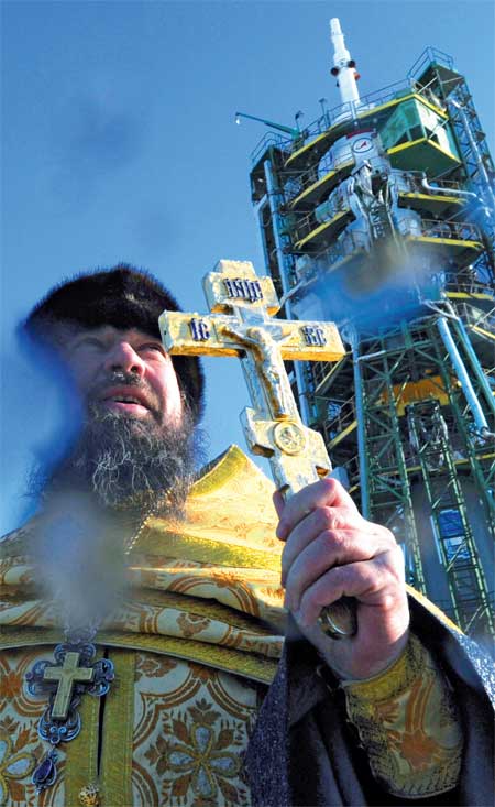 A Russian Orthodox priest blesses the Soyuz TMA- 03M spacecraft at the launch pad of the Baikonur cosmodrome Tuesday. The launch of the Soyuz TMA- 03M with an international crew of US astronaut Donald Pettit, Russian cosmonaut Oleg Kononenko and Dutch astronaut Andre Kuipers is scheduled for Wednesday. Photo: AFP