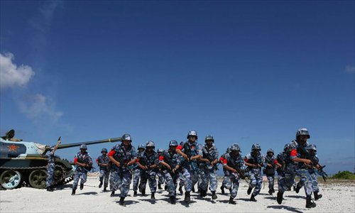 Soldiers participate in a cross-country run in full battle gear as part of a military training competition by the People’s Liberation Army (PLA) held on the Xisha islands in the South China Sea on December 5. Photo: mil.cnr.cn