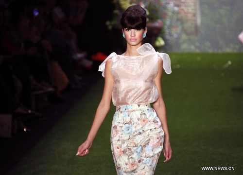 A model presents a creation by Austrian designer Lena Hoschek at the Spring/Summer 2014 Shows of the Mercedes-Benz Fashion Week, in Berlin, on July 2, 2013. (Xinhua/Pan Xu) 