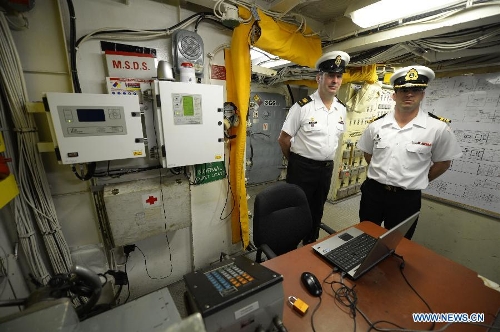 Chief Petty Officer Boulac (L) and Engineering Officer Roberge are seen inside the Machinery Control Room of the Royal Canadian Navy destroyer HMCS Algonquin during a media presentation in Vancouver, Canada, on April 26, 2013. Approximately 1,000 Canadian and American sailors are in Vancouver to meet members of the public and media to bring the Navy to the Canadians. (Xinhua/Sergei Bachlakov) 