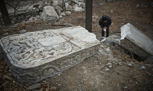 A resident looks at the broken stele,  at Fahai Temple in Haidian district Wednesday. Photo: Li Hao/GT