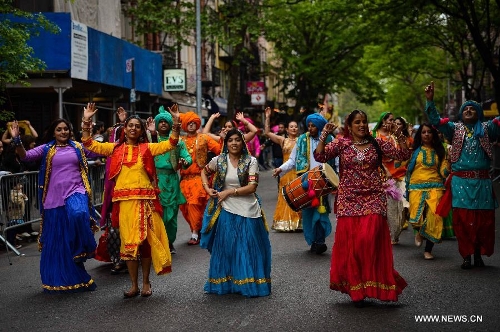 People participate in the annual Dance Parade in New York, on May 18, 2013. Over 200 dance groups showcasing 80 unique dance styles and cultures gathered from Broadway to the East Village on Saturday for the 7th Dance Parade in New York. (Xinhua/Niu Xiaolei) 
