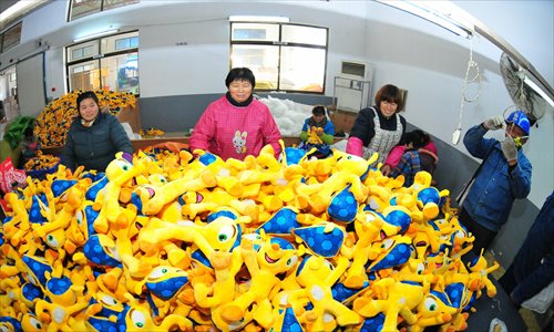 A worker sorts through stuffed toys for export in Chuzhou, East China's Anhui Province. Photo: IC