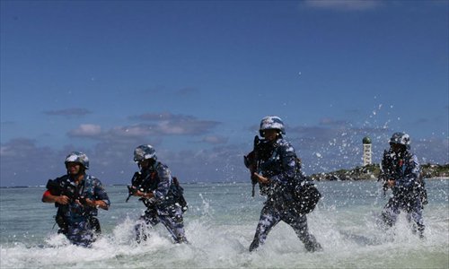 Soldiers race through shallow water towards the finish line during a PLA military training competition held on the Xisha Islands, South China Sea on December 5. Photo: mil.cnr.cn