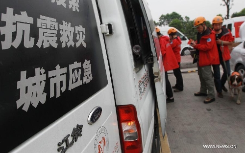 Members of the Ramunion Rescue, a rescue team from Hangzhou, capital of east China's Zhejiang Province, prepare to set off for the quake-hit region at the Xinjin Service Area on the Chengdu-Ya'an Highway after 22-hour drive in Ya'an, southwest China's Sichuan Province, April 21, 2013. Six members of the Hangzhou Outdoors Emergency Rescue Team arrived in the earthquake-hit Ya'an City after driving for consecutive 22 hours on Sunday. (Xinhua/Pei Xin) 
