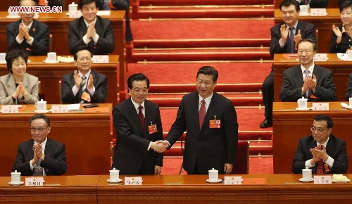 Hu Jintao congratulates Xi Jinping at the fourth plenary meeting of the first session of the 12th National People's Congress (NPC) in Beijing, capital of China, March 14, 2013. Xi was elected president of the People's Republic of China (PRC) and chairman of the Central Military Commission of the PRC at the NPC session here on Thursday. (Xinhua/Jin Liwang)