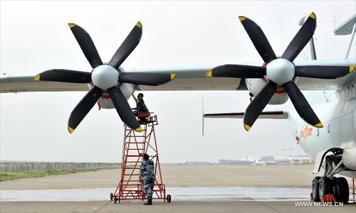 Maintenance staff members of Bayi Aerobatic Team of the People's Liberation Army (PLA) Air Force, check a plane in Zhuhai, south China's Guangdong Province, November 12, 2012. The 9th China International Aviation and Aerospace Exhibition will kick off on Tuesday in Zhuhai. Photo: Xinhua