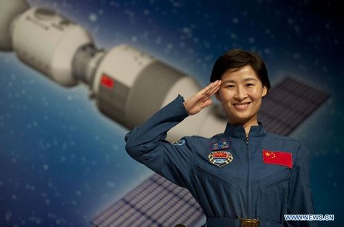 China's first woman astronaut Liu Yang salutes at a press conference in South China's Hong Kong, August 10, 2012. A 40-plus-member delegation of Tiangong-1/Shenzhou-9 Manned Space Docking and Rendezvous Mission, including three astronauts who had fulfilled China's first manned space docking mission this June, arrived at Hong Kong Friday for a four-day visit. Photo: Xinhua