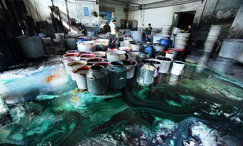 Staff work at a printing and dyeing mill in the Shaoxing Binhai Industrial Zone in Shaoxing, Zhejiang Province. Each time fabrics were dyed, they had to be washed, causing serious pollution. Photo: Courtesy of  Greenpeace
