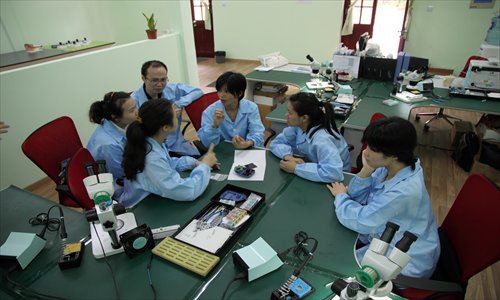 Hearing impaired employees of Solar Ear China enjoy a break from work. 
Photo: Courtesy of Solar Ear China
