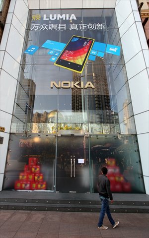 A passerby walks past Nokia's flagship store on Nanjing Road East Tuesday. The former mobile phone giant closed the store Monday with the explanation that it was 