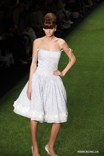 A model presents a creation by Austrian designer Lena Hoschek at the Spring/Summer 2014 Shows of the Mercedes-Benz Fashion Week, in Berlin, on July 2, 2013. (Xinhua/Pan Xu) 