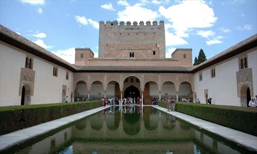 Tourists enjoy an interior courtyard at Granada's L'Alhambra. Photo: CFP