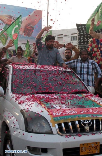 Supporters of Pakistan Muslim league Functional (PML-F) march on a car as part of an election campaign in southern Pakistani port city of Karachi on May 4, 2013. Pakistan is scheduled to hold parliamentary elections on May 11. (Xinhua/Arshad)