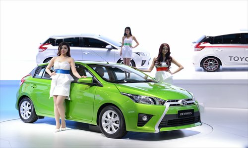 Models pose with Toyota's Yaris at the 2013 Shanghai Auto Show on April 20. Photo: CFP