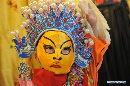 Shi Zhixuan, a three-year-old face change performer, practises at home in Guilin, a tourist resort in Southwest China's Guangxi Zhuang Autonomous Region, August 20, 2012. Face change is a famous skill mostly used in Sichuan Opera to demonstrate sudden changes of the role's emotions. Shi Zhixuan started to learn the skills of changing face half a year ago, and now she has a good command of face changes in four categories. Photo: Xinhua
