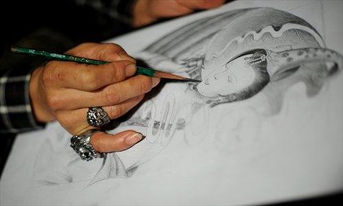 Liu Jinlong, a tattoo artist in Taiyuan, Shanxi Province, practises sketches. Photo: CFP