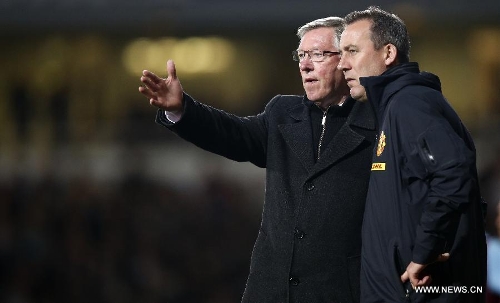 Manchester United manager Sir Alex Ferguson (L) communicates with his assistant Rene Meulensteen during the Barclays Premier League match between West Ham United and Manchester United at Upton Park in London, Britain, on April 17, 2013. The match ended with a 2-2 draw. (Xinhua/Wang Lili) 