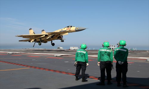 A J-15 fighter jet prepares to land on the carrier, the Liaoning, during the 25-day test and training session, which concluded on Wednesday. Photo: CFP