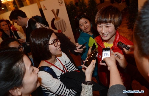 Chinese player Ding Ning (R) is interviewed after the official draw of the upcoming World Table Tennis Championships in Paris, France, May 11, 2013. The world championships will kick off on May 13 and the final event will be held on May 20. (Xinhua/Tao Xiyi)