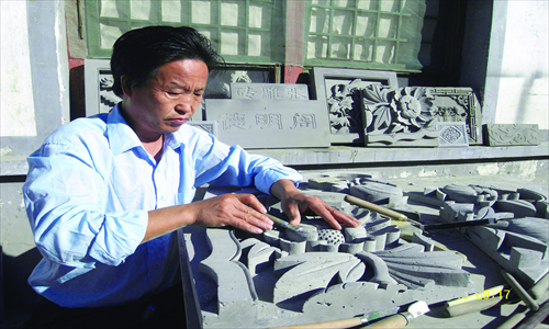 Touching up a design 
Photo: Courtesy of Zhang Yan