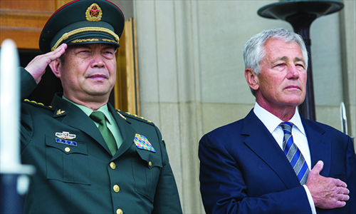 Chinese Minister of National Defense Chang  Wanquan (left) and US Secretary of Defense Chuck Hagel listen to their respective national anthems during an arrival ceremony for Chang at the Pentagon in Washington, DC on Monday. Photo: AFP