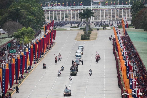 Image provided by Venezuela's Presidency shows the transfer of the body of late Venezuelan President Hugo Chavez from the Military Academy to the Mountain Barracks, in the city of Caracas, capital of Venezuela, on March 15, 2013. Hundreds of thousands of Venezuelans Friday marched alongside the casket of their late President Hugo Chavez, as his remains were taken to the mountaintop barracks he once called home and today houses the Historic Military Museum. (Xinhua/Venezuela's Presidency)