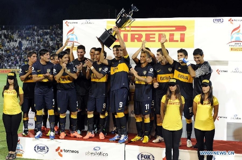 Players of Boca Juniors celebrate their victory against River Plate during the awarding ceremony after the second match of the 