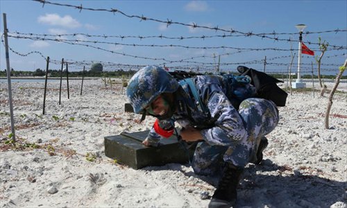 A solider crawls through steel mesh as part of a military training competition held by the PLA on the Xisha Islands, December 5. Photo: mil.cnr.cn