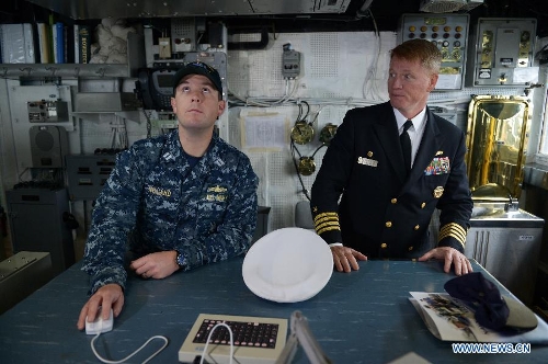 Ship's Commanding Officer Christopher K. Barnes (R) and Combat Systems Officer Noland are seen inside the Navigation Control Room on board of the U.S. Navy guided-missile cruiser USS Lake Champlain during a media presentation in North Vancouver, Canada, on April 27, 2013. Approximately 1,000 Canadian and American sailors are in Vancouver to meet the public and media to bring the Navy to the Canadians. (Xinhua/Sergei Bachlakov) 