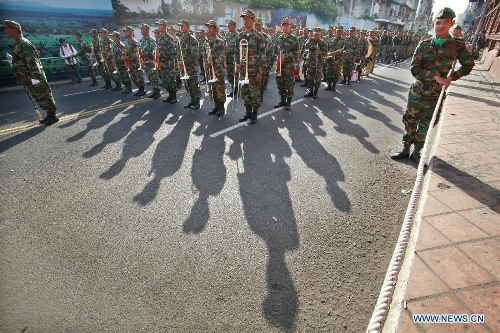 Cambodian troops march in front of the Royal Palace in preparation for the funeral of late King Father Norodom Sihanouk in Phnom Penh, Cambodia, Jan. 19, 2013. Sihanouk died of illness at the age of 90 in Beijing on Oct. 15, 2012. His body will be moved to a custom-built crematorium at the Meru field next to the Royal Palace on Feb. 1 and kept it for another three days at the site before it is cremated on Feb. 4. (Xinhua/Sovannara) 
