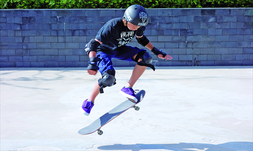 A child performs a skateboard trick. Photo: Coutesy of James Herrmann