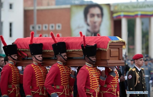 The body of late Venezuelan President Hugo Chavez is carried from the Military Academy to the Mountain Barracks, in the city of Caracas, capital of Venezuela, on March 15, 2013. Venezuelans honored late President Hugo Chavez, before his remains were transfered to the Mountain Barracks, where he will rest inside a glass case. Venezuelan President died on March 5, after struggling with cancer for two years. (Xinhua/AVN) 