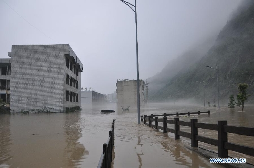 Buildings are flooded in rainstorm-hit Beichuan Qiang Autonomous County, southwest China's Sichuan Province, July 9, 2013. Downpours have submerged the quake-razed old town ruins of Beichuan, which was hit by an 8.0-magnitude earthquake in May 2008. (Xinhua)