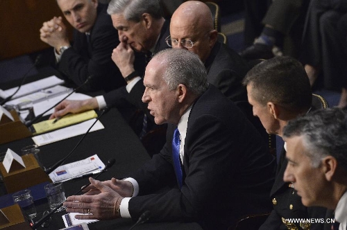 (L to R) National Counterterrorism Center Director Matthew Olsen, FBI Director Robert Mueller, Director of National Intelligence James Clapper, CIA Director John Brennan, Defense Intelligence Agency Director Michael Flynn, and Assistant Secretary of State for Intelligence and Research Philip Goldberg, testify before the Senate Select Intelligence Committee during a hearing on 