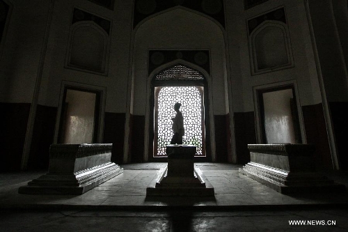 Tourists visit Humayun's Tomb in New Delhi, capital of India, May 12, 2013. Humayun's Tomb, located in east New Delhi, was built in 1569 to 1570 by Humayun's widow. As a precursor to the Taj Mahal, it stands on a platform of 12,000 square meters and reaches a height of 47 meters. The earliest example of the Persian influence in Indian architecture, the tomb itself is in the center of a large garden, surrounded by 12 hectares of gardens with pools joined by channels. The tomb brought Persian style to Delhi, but the two-tone combination of red sandstone and white marble is local, which shows the merging of different cultures. Humayun's Tomb was inscribed on the World Heritage List by the United Nations Educational, Scientific and Cultural Organization in 1993. (Xinhua/Zheng Huansong) 