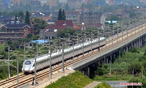 A bullet train traveling between Hangzhou and Nanjing runs on the railway in Huzhou in east China's Zhejiang Province, July 1, 2013. The Nanjing-Hangzhou-Ningbo high-speed railway that stretches across east China's Yangtze River Delta began officially put into operation on July 1. The new high-speed railway is expected to boost the region's economy and foster the growth of tourism in the three cities it links (Xinhua/Wang Dingchang)