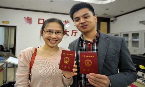 A couple show their marriage certificates at the marriage registration office in Haikou, capital of South China's Hainan Province, January 4, 2013. Quite a number of couples flocked to tie the knot on January 4, 2013, or 2013/1/4, which sounds like 