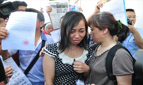 Tang Hui, the mother from Yongzhou, Hunan Province, is surrounded by her supporters outside the Hunan Provincial High People's Court in Changsha before her second hearing on Tuesday. Photo: CFP