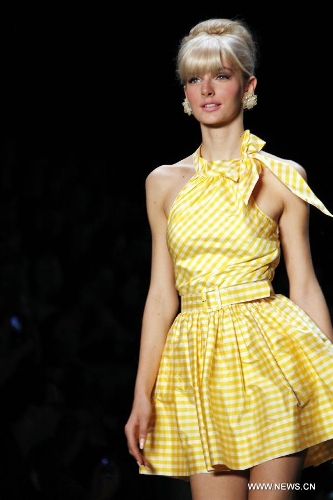 A model presents a creation by Austrian designer Lena Hoschek at the Spring/Summer 2014 Shows of the Mercedes-Benz Fashion Week, in Berlin, on July 2, 2013. (Xinhua/Pan Xu) 