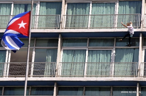 The so-called French Spiderman, Alain Robert, scales the landmark Havana Libre hotel without safety equipment in Havana, Cuba, on Feb. 4, 2013. (Xinhua/Joaquin Hernandez) 