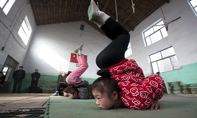Girls train their flexibility in Ningjin Acrobatics Arts School in Shandong Province. Photo: CFP