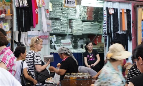Chinese businessmen sell goods in Zhonghai market in Bishkek, Kyrgyzstan. Around 160 stalls run by Chinese are in the market, occupying half of the space. Photo: courtesy of Wang Xiaohuang
