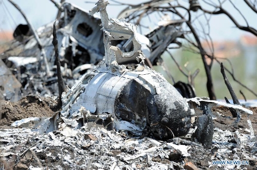 Photo taken on May 16, 2013 shows the remains of a light plane after it failed to take off at Taoxian Airport in Shenyang, capital of northeast China's Liaoning Province. Three people on board were injured in the accident on Thursday. (Xinhua/Yang Qing)
