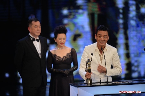 Actor Tony Leung (R) receives the Best Actor award for his movie 