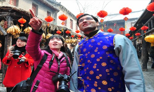 A Kenyan student listens to a guide describing the old town of Zhoucun in Zibo, Shandong Province on February 10. Photo: IC